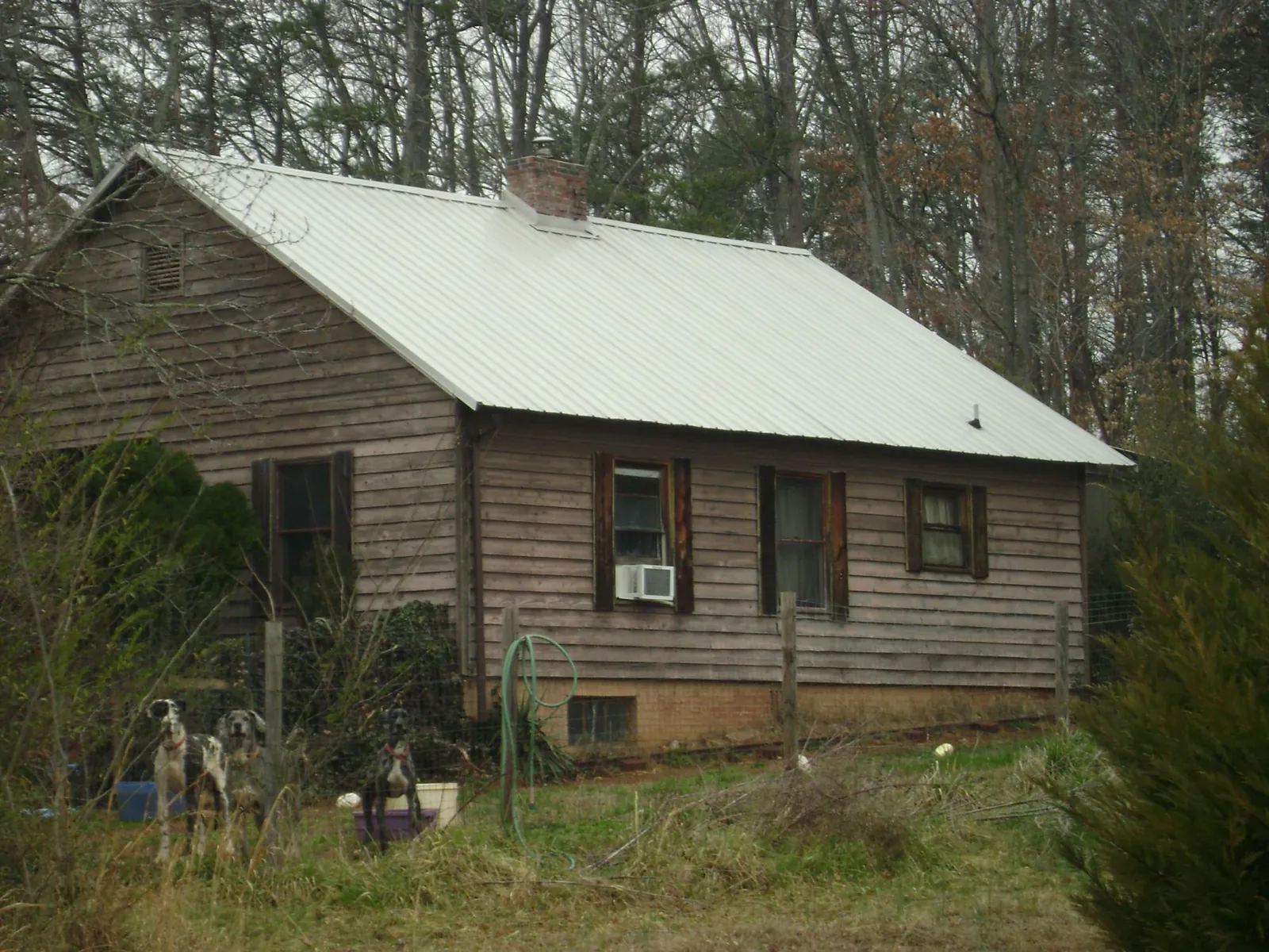 White metal roof on an old wood sided farmhouse, from a Metal Roof Installation job in Edinburg